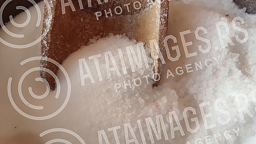 Wooden bowl with salt and spoon in it. So i kasika u drvenoj ciniji.