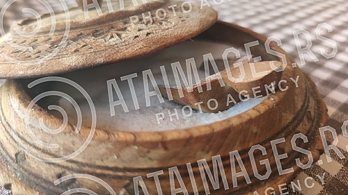 Wooden bowl with salt and spoon in it. So i kasika u drvenoj ciniji.