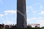 The Washington Monument, a monument to George Washington, the first President of the United States, is one of the most prominent landmarks in Washington and stands as a central part of the National Mall, and is surrounded by American flags. Vasingt