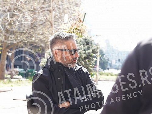 Director Srdan Golubovic is sitting in the garden of a cafe on Nikola Pasic Square.Reditelj Srdan Golubovic sedi u basti kafica na Trgu Nikole Pasica.