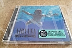 Cover and CD Nevermind, the second studio album of the American music group Nirvana, released on September 24, 1991 by Geffen Records.Omot i CD-a Nevermind, drugog studijskog albuma americke muzicke grupe Nirvana, objavljenog 24. septembra 1991. u
