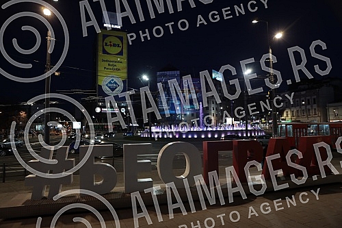Roundabout on Slavija Square with illuminated fountain at night.Kruzni tok na Trgu Slavija  sa osvetljenom fontanom nocu.